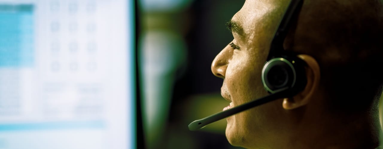 Photo of a man wearing a phone headset